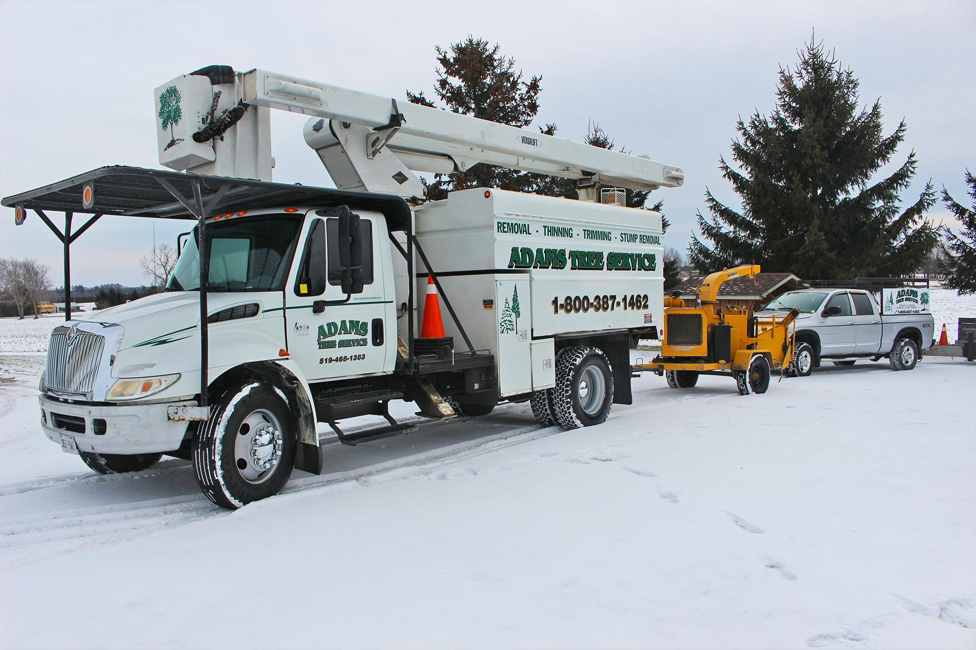 Adams Tree Service line truck and chipper